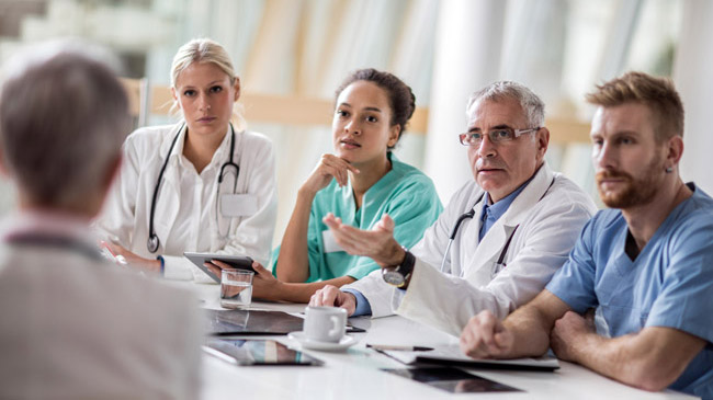 Physicians talking around a table